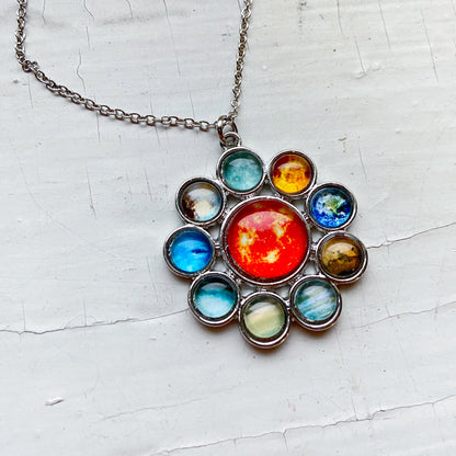Necklace with a colorful pendant on a textured white background