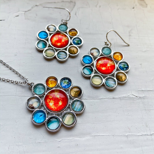 Colorful celestial-themed jewelry set on a light gray background