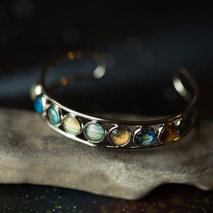 Silver bracelet with colorful stones on a dark background