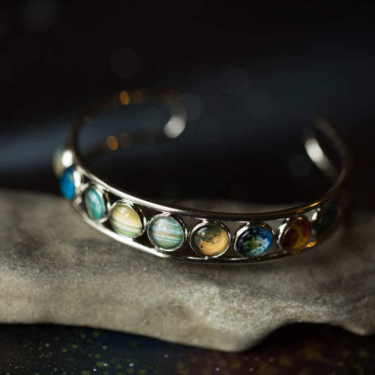 Silver bracelet with colorful stones on a dark background