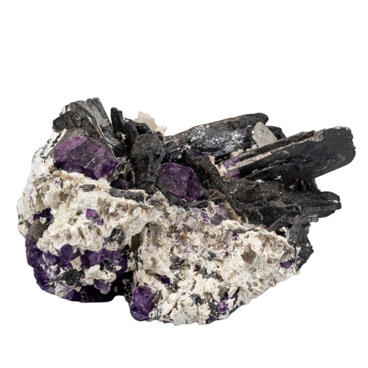 Quartz crystal with purple and black crystals on a white background