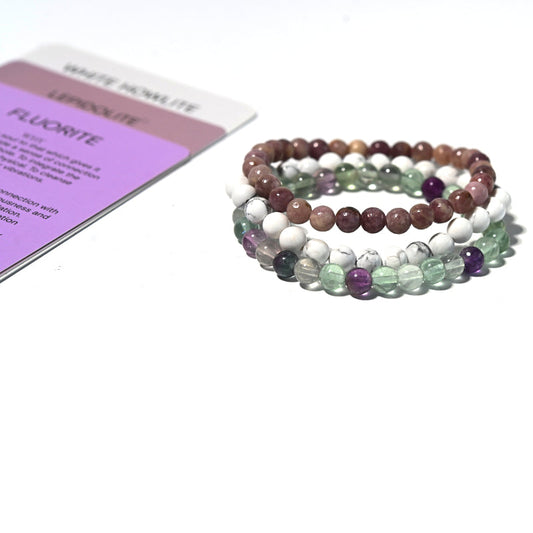 Set of three beaded bracelets with a colorful stone pattern on a white background.