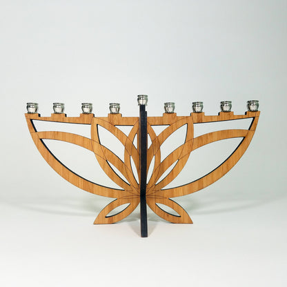 Wooden menorah with a black central stem on a white background