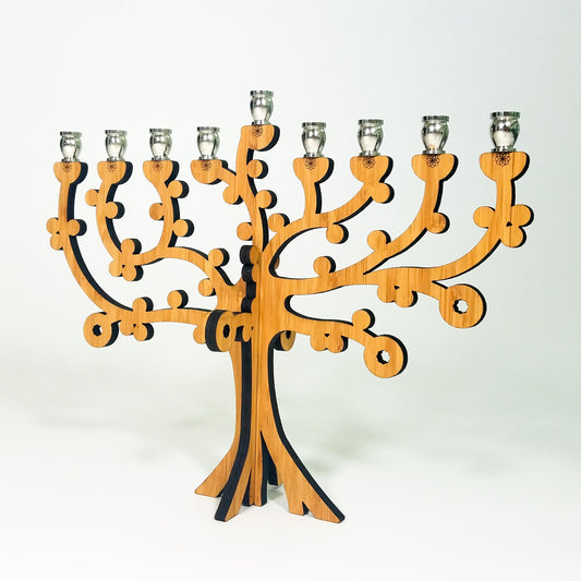 Wooden menorah designed like a tree on a white background