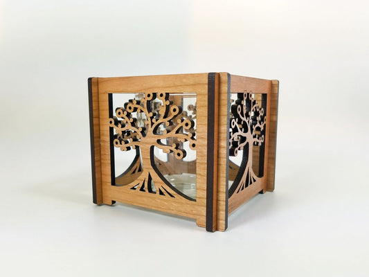 Wooden decorative candle holder with tree of life design on a white background