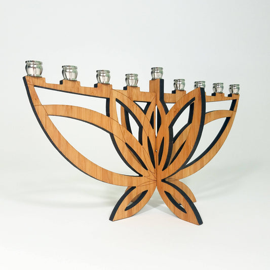 Wooden menorah with leaf design on a white background