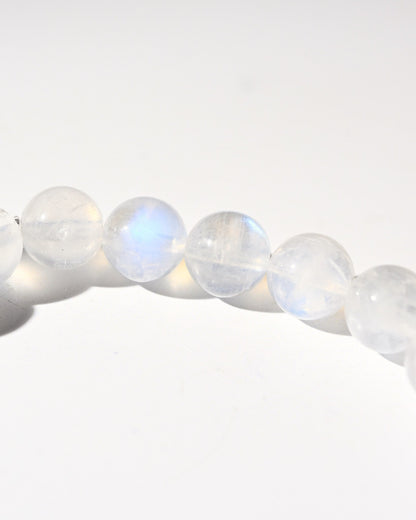 Close-up of rainbow moonstone beads on a white background