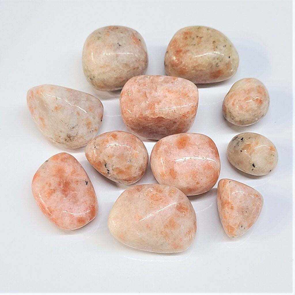 collection of sunstone crystals on a light background